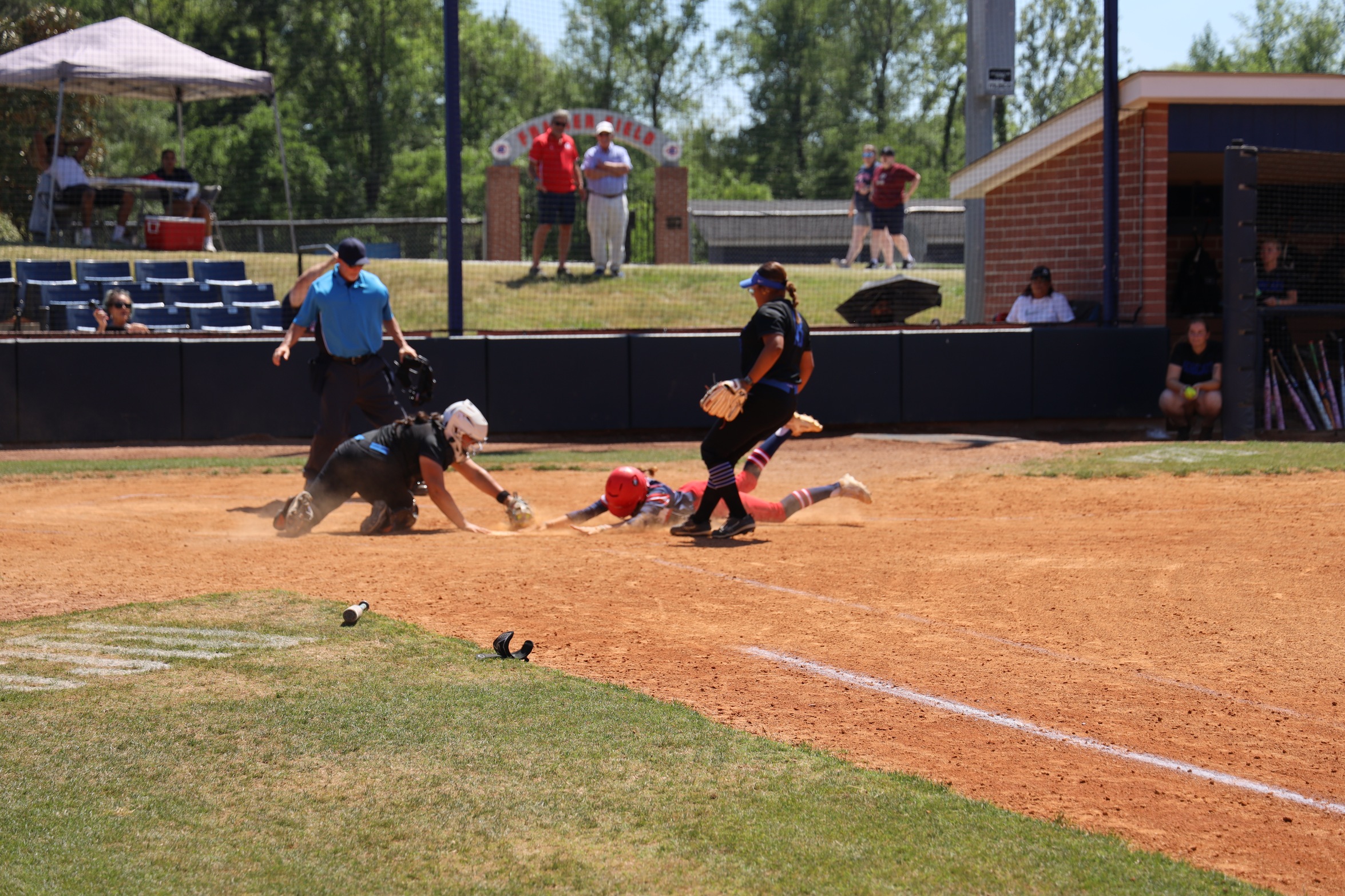 Hurricanes player dives head first into home plate.