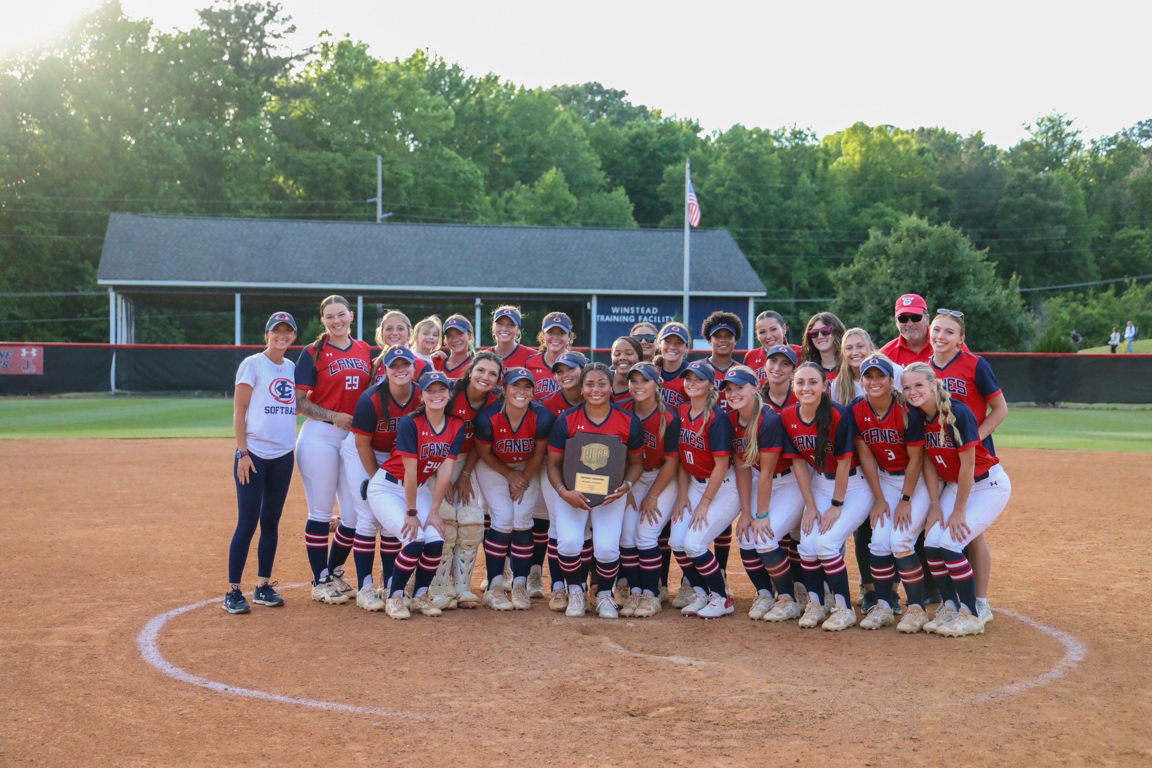 2026 Softball Team Pose with District Championship Trophy
